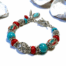 Rood met turquoise bedelarmband in zilver